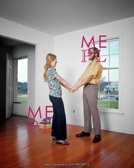 : Smiling Young Couple Holding Hands in Their Empty : Smiling Young Couple Holding Hands in Their Empty