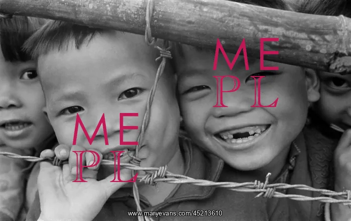 : Smiling youngsters press against a barbed ? : Smiling youngsters press against a barbed ?