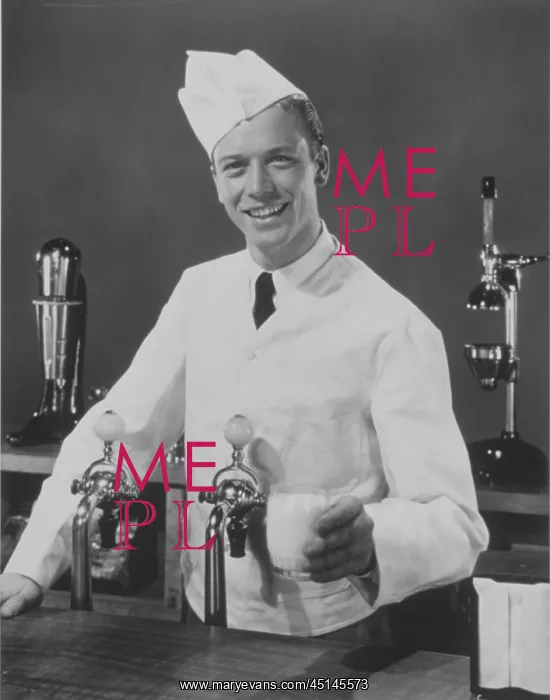 : Soda Jerk. Young man I white jacket and had as soda jerk, serving glass of milk : Soda Jerk. Young man I white jacket and had as soda jerk, serving glass of milk