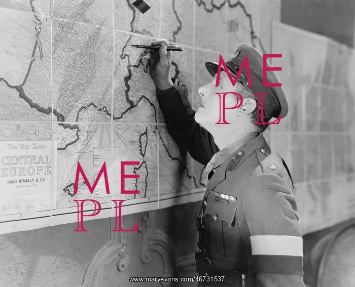 : Soldier looking at a map marking it with a pen : Soldier looking at a map marking it with a pen