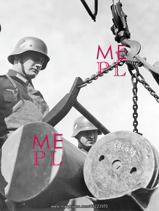 : Soldier next to projectiles on a crane : Soldier next to projectiles on a crane