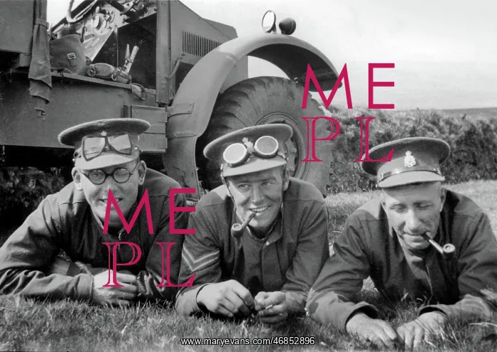 : Three soldiers lying on the grass by their jeep : Three soldiers lying on the grass by their jeep