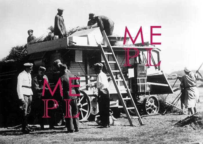 : Soldiers stand by a threshing machine : Soldiers stand by a threshing machine