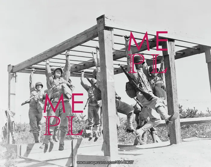 : Soldiers swinging across horizontal ladders : Soldiers swinging across horizontal ladders