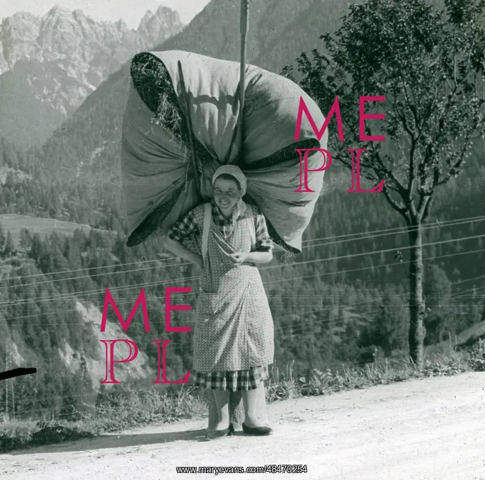  : Spanish woman carrying a massive bundle of hay