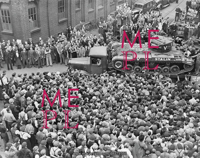 : A Stalin tank makes its way through crowds of : A Stalin tank makes its way through crowds of