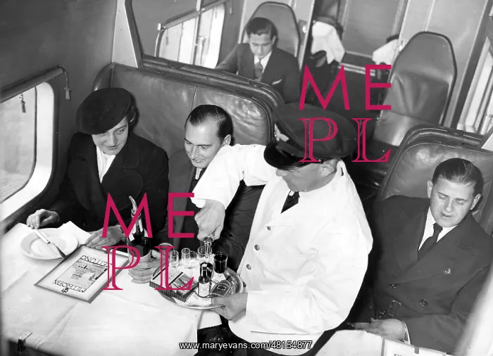 : Steward serves passengers on board a Junkers G-38, 1937 : Steward serves passengers on board a Junkers G-38, 1937