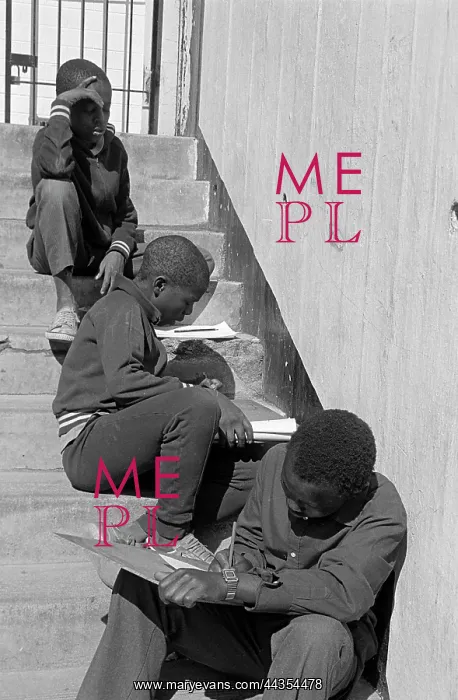 : Street children doing school work on steps outside : Street children doing school work on steps outside