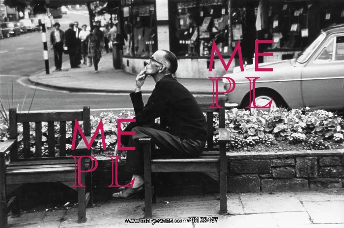 : Street scene with man smoking on a bench : Street scene with man smoking on a bench