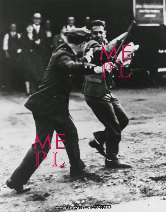 : A striker dodges policeman's night stick during : A striker dodges policeman's night stick during