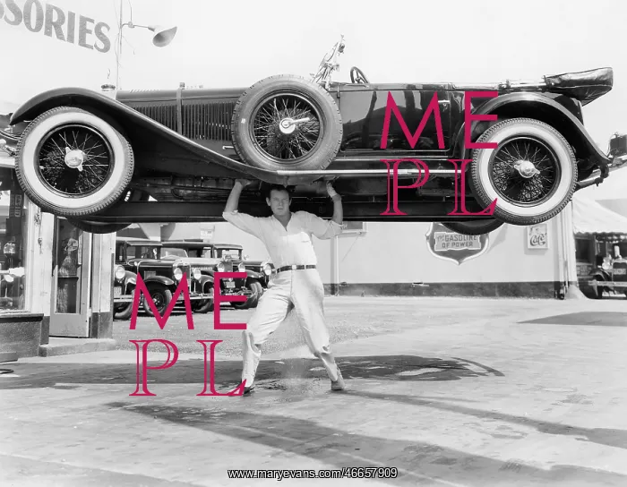 : Strong man lifting a car over his head : Strong man lifting a car over his head
