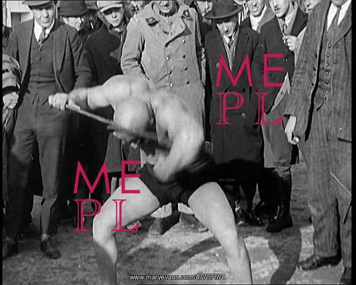 : A Strongman Bending An Iron Bar Around His Head : A Strongman Bending An Iron Bar Around His Head
