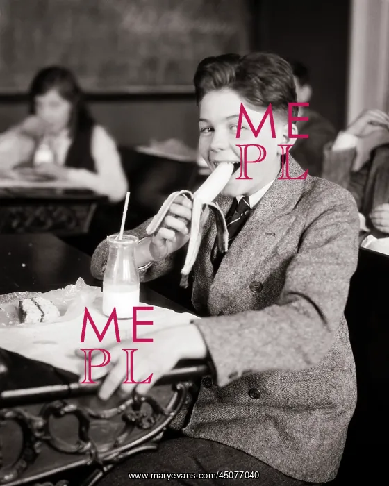: Student Eating Snack at his School Desk : Student Eating Snack at his School Desk