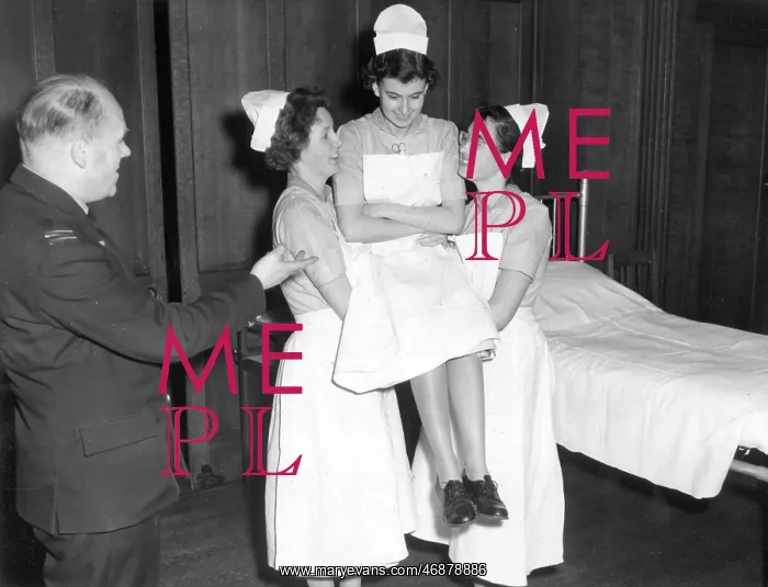 : Student nurses practising three handed lift : Student nurses practising three handed lift