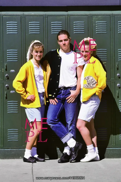 : Three Students by Lockers Dressed in Clothes Looking : Three Students by Lockers Dressed in Clothes Looking