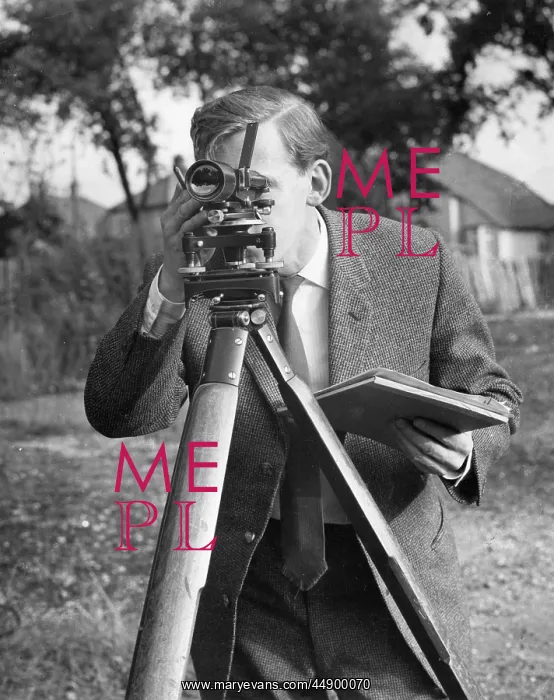 : Surveyor at work with a theodolite : Surveyor at work with a theodolite