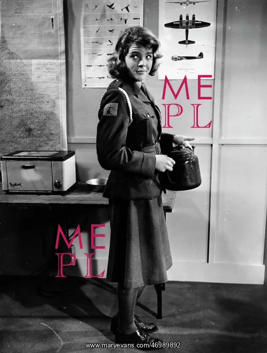 : Swimmer Judy Grinham standing in uniform : Swimmer Judy Grinham standing in uniform