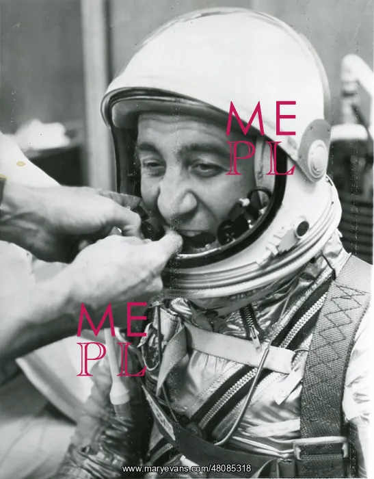 : A technician adjusts the microphones for astronaut Virg? : A technician adjusts the microphones for astronaut Virg?