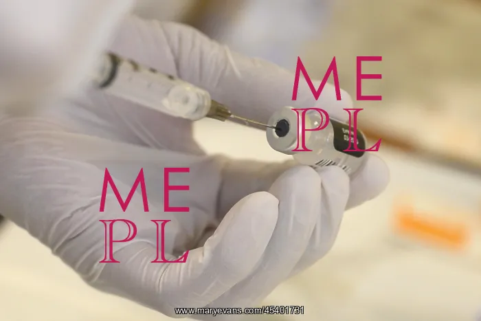 : A technician loads a syringe with COVID-19 vaccine : A technician loads a syringe with COVID-19 vaccine