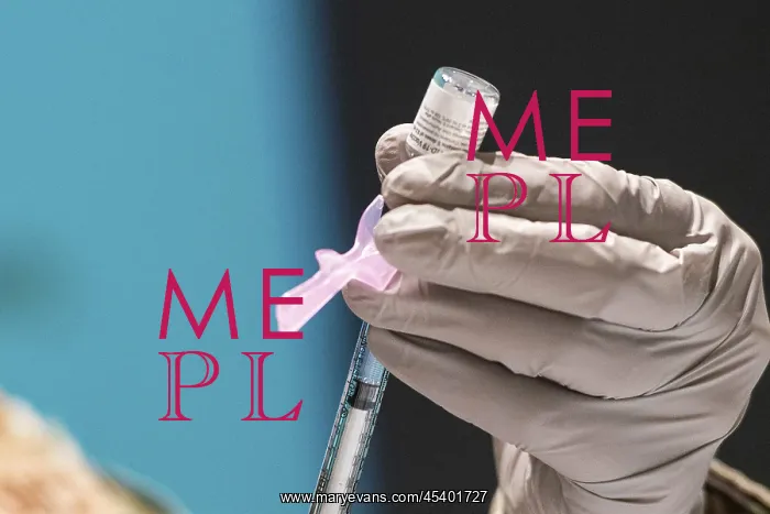 : A technician loads a syringe with the Pfizer-BioNTech : A technician loads a syringe with the Pfizer-BioNTech