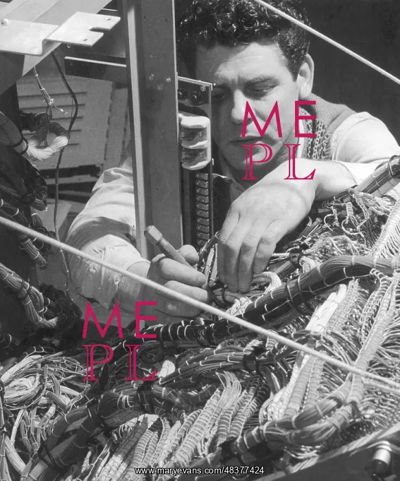 : A technician works on a wiring system : A technician works on a wiring system