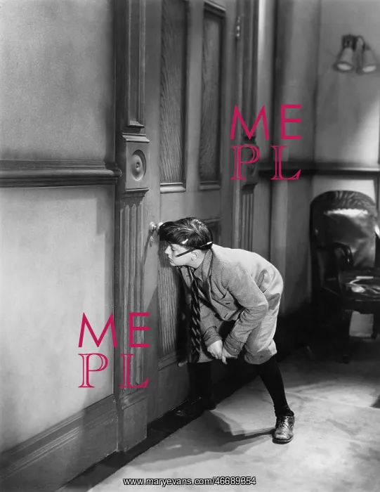 : Teenage boy peeping through keyhole : Teenage boy peeping through keyhole