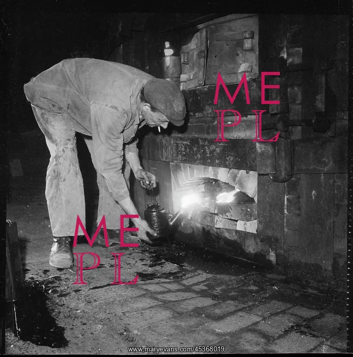 : Tending the fire beneath a kiln at a pottery works : Tending the fire beneath a kiln at a pottery works