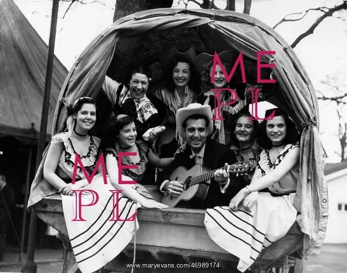 : Tennessee Ernie playing guitar in a wagon : Tennessee Ernie playing guitar in a wagon