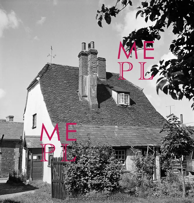 : Thaxted. The rear elevation of a house with a half hipped roof, central chimney stacks : Thaxted. The rear elevation of a house with a half hipped roof, central chimney stacks