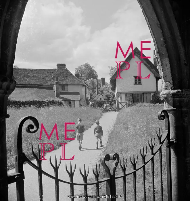 : Thaxted. Two young boys walk along a path through Thaxted churchyard path : Thaxted. Two young boys walk along a path through Thaxted churchyard path