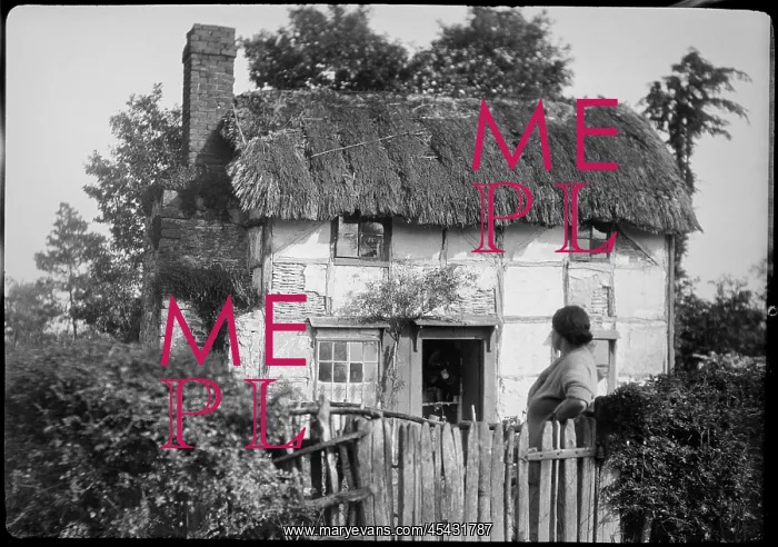  : The front of a timber framed thatched cottage in Woolhope