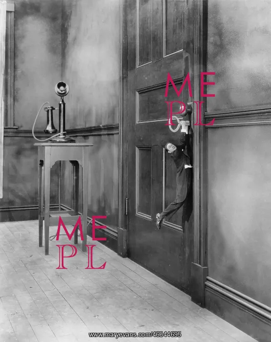 : Tiny man hanging from key in door : Tiny man hanging from key in door