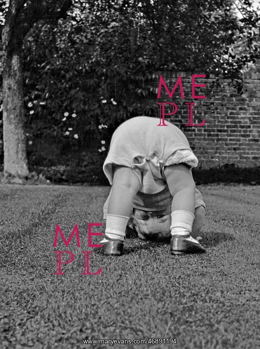  : Toddler bending over in a garden