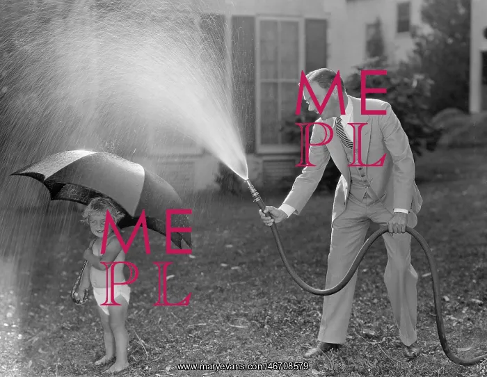 : Toddler and dad playing with hose in yard : Toddler and dad playing with hose in yard