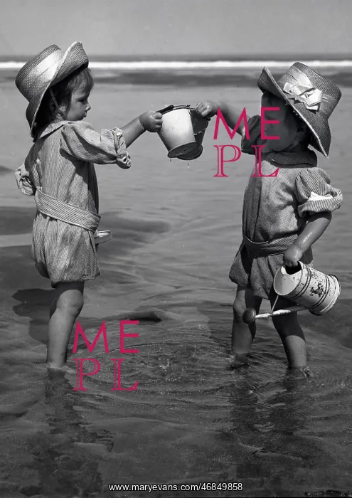 : Two toddlers paddling in the sea : Two toddlers paddling in the sea