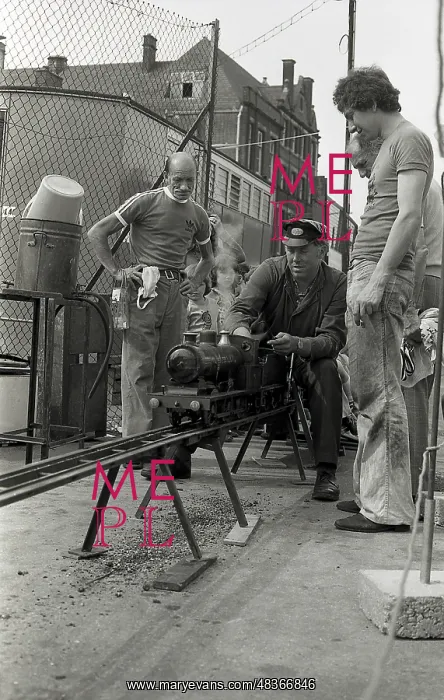 : Train driver prepares engine on model steam train : Train driver prepares engine on model steam train
