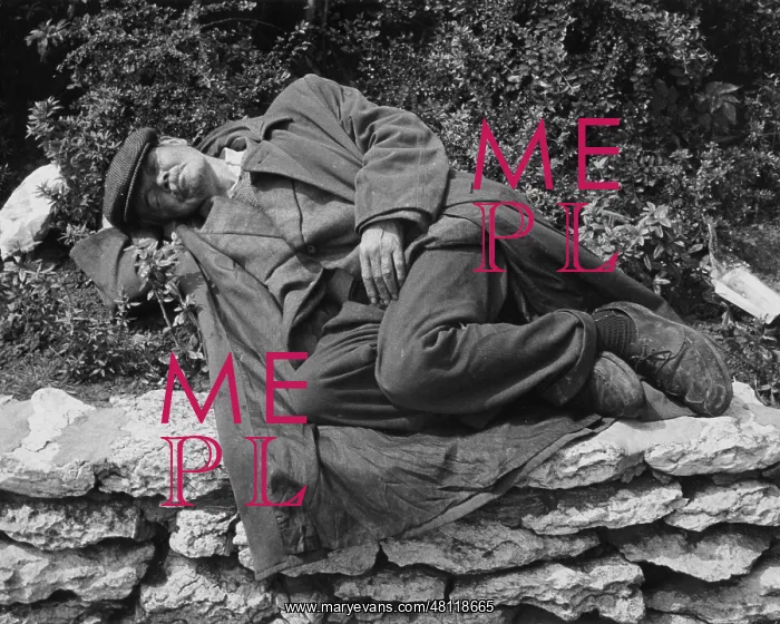 : Tramp asleep on a flowerbed in Manchester : Tramp asleep on a flowerbed in Manchester
