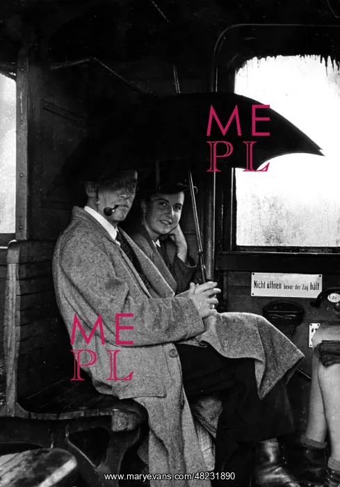 : Travelers with an open umbrella in a train compartment : Travelers with an open umbrella in a train compartment
