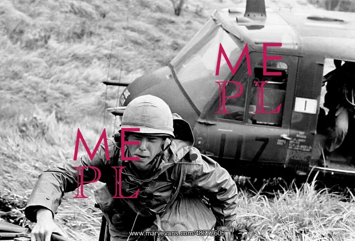 : Troops make an air assault from a UH-1 Huey into : Troops make an air assault from a UH-1 Huey into