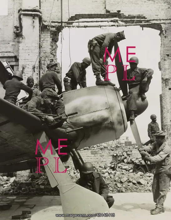 : Troops removing pieces from a grounded fighter : Troops removing pieces from a grounded fighter