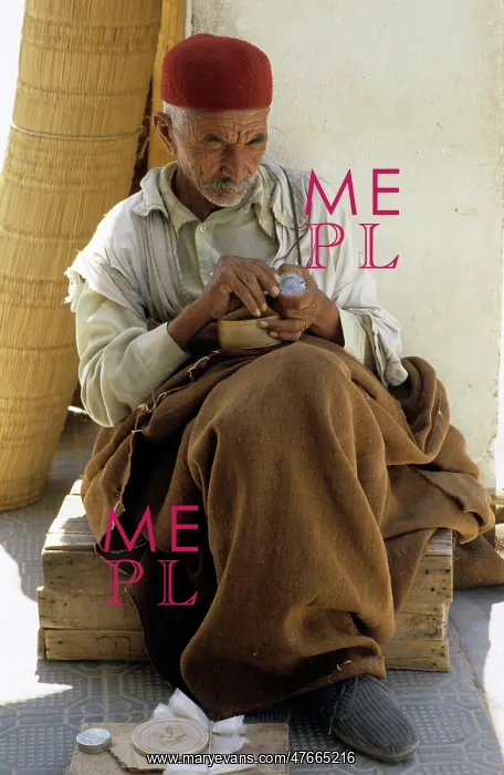 : Tunisian man sits in shade : Tunisian man sits in shade