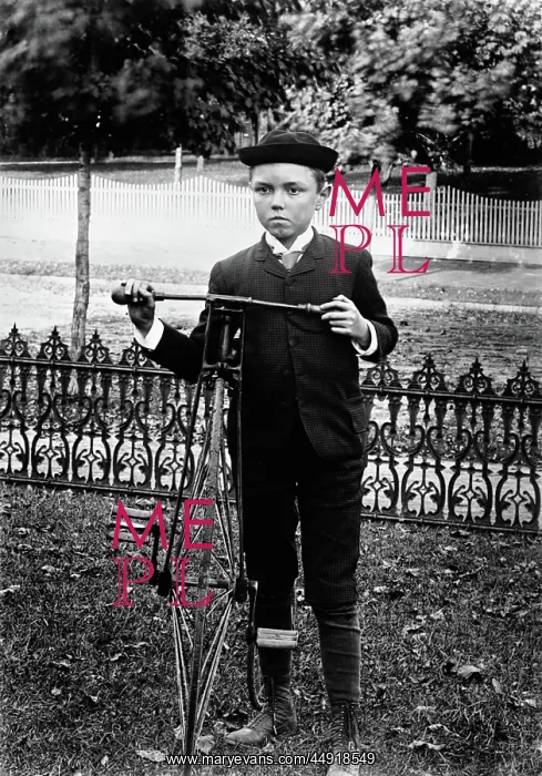 : Turn of the century boy standing in yard next : Turn of the century boy standing in yard next