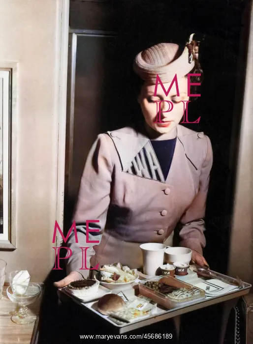 : TWA air stewardess with an in-flight meal : TWA air stewardess with an in-flight meal