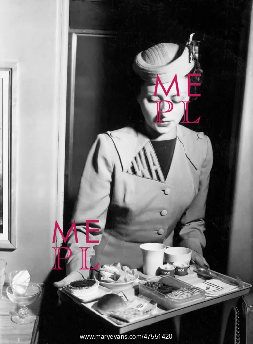 : TWA air stewardess with an in-flight meal : TWA air stewardess with an in-flight meal