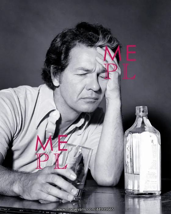 : Unfortunate Middle Age Man Sitting at Table Holding : Unfortunate Middle Age Man Sitting at Table Holding