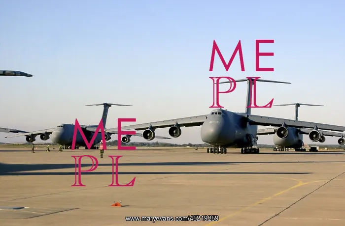 : An U.S. airman dwarfed by a C-5 Galaxy cargo ? : An U.S. airman dwarfed by a C-5 Galaxy cargo ?