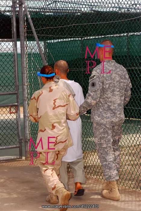 : U.S. Army and Navy guards escort a detainee ? : U.S. Army and Navy guards escort a detainee ?