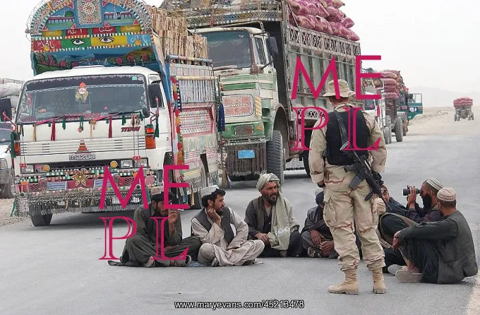 : A U.S. Army soldier with Afghani men while ? : A U.S. Army soldier with Afghani men while ?
