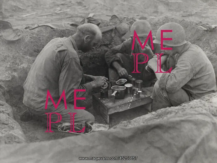 : Three U.S. Army soldiers eat rations in a foxhole : Three U.S. Army soldiers eat rations in a foxhole
