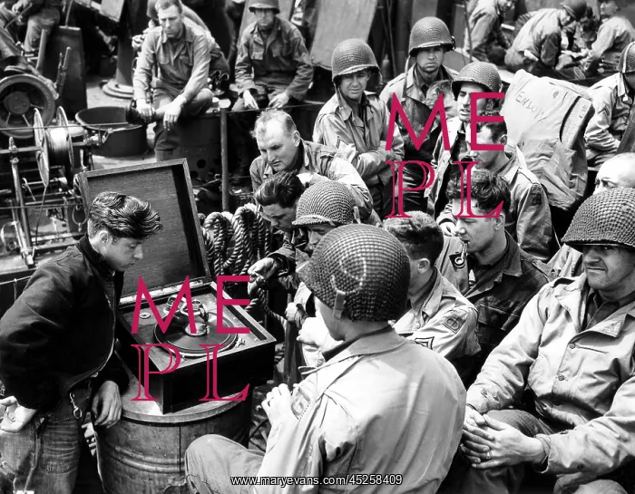 : U.S Infantrymen listen to a phonograph on their : U.S Infantrymen listen to a phonograph on their